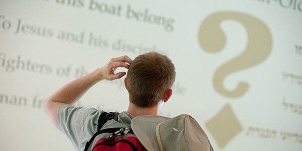 Man looking at question mark