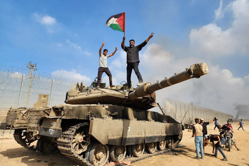 Hamas militiamen capture IDF tank on October 7. (Credit: Getty Images)
