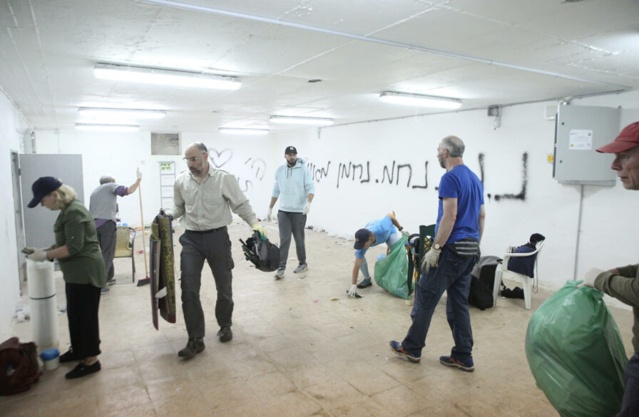 Christian volunteers renovate a bomb shelter during an ICEJ Hands-On Tour