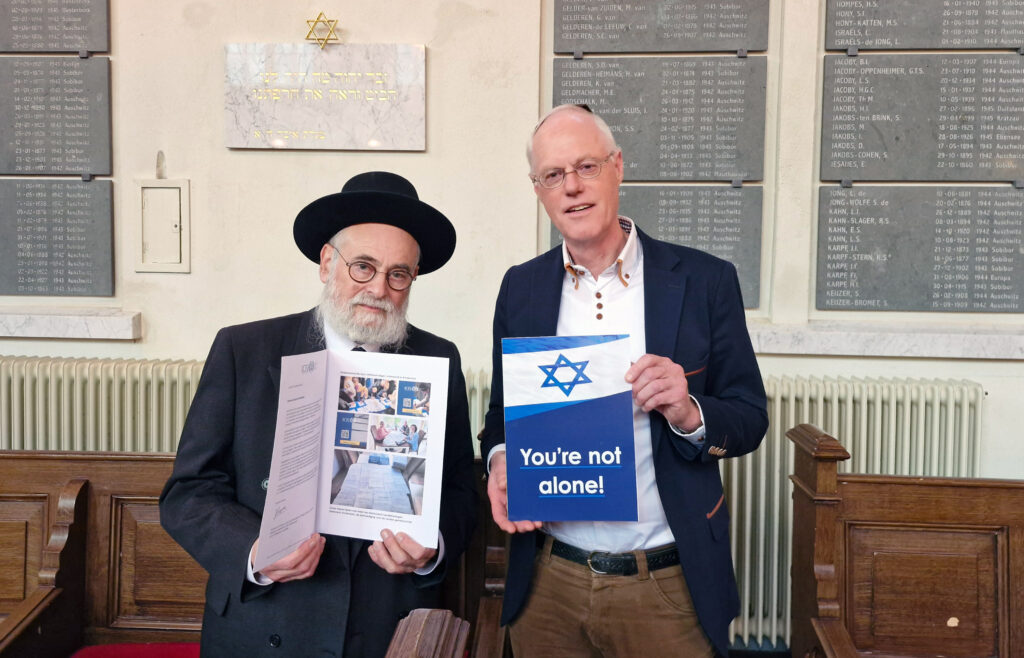 Opperrabbijn Binyomin Jacobs ontvangt van Jacob Keegstra het statement en een kaart met de tekst You're not alone