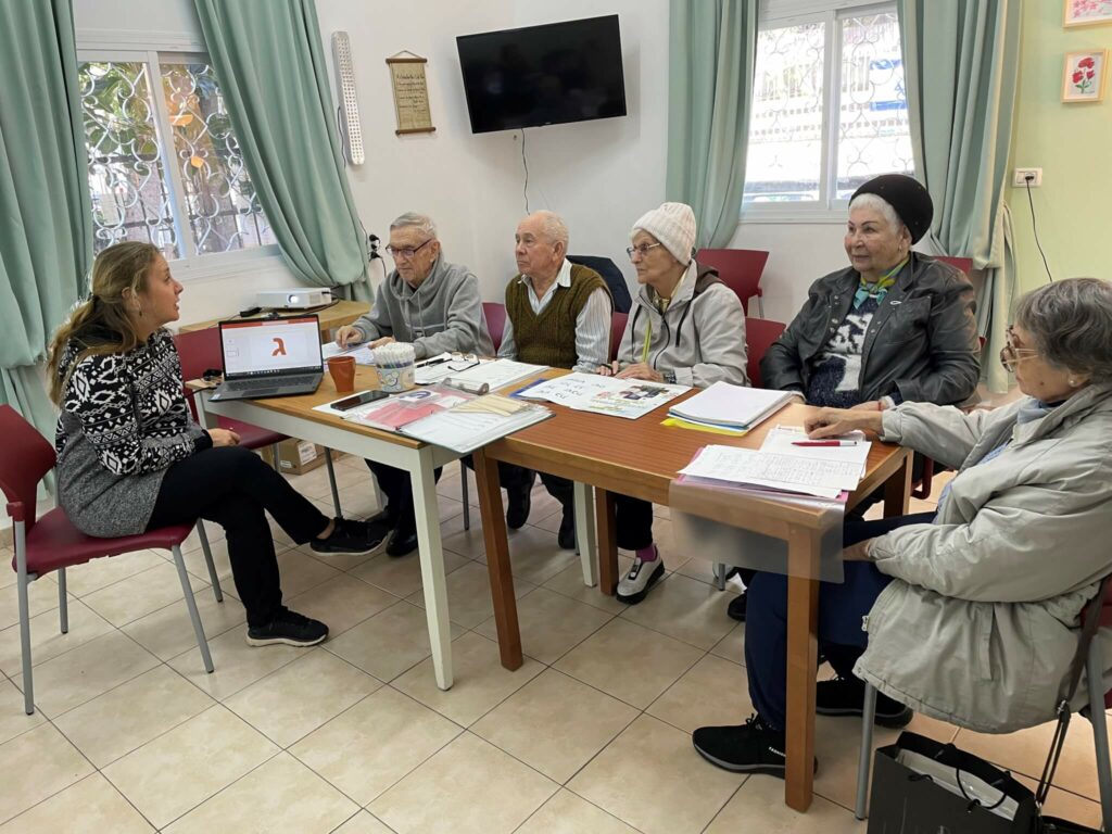 Maria (L) teaching a Hebrew class.