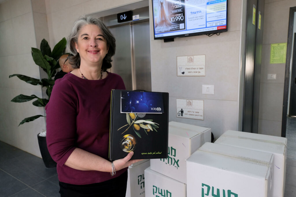 Nicole Yoder, ICEJ Vice President for AID & Aliyah, holding a gift package.