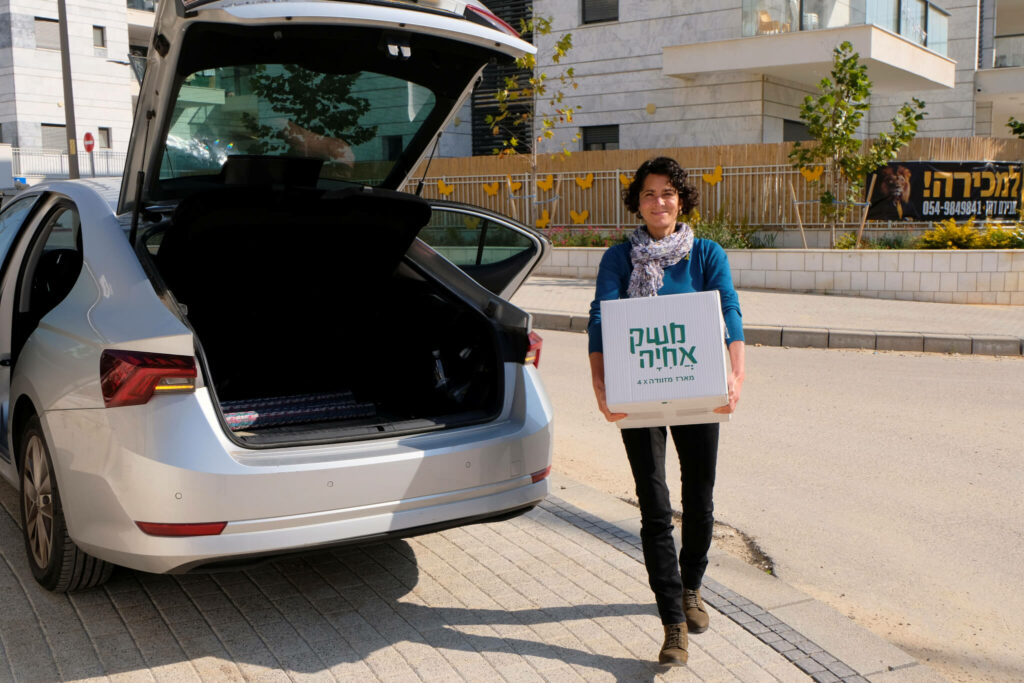 ICEJ staff delivering gift packages for the Tu B'Shvat holiday.