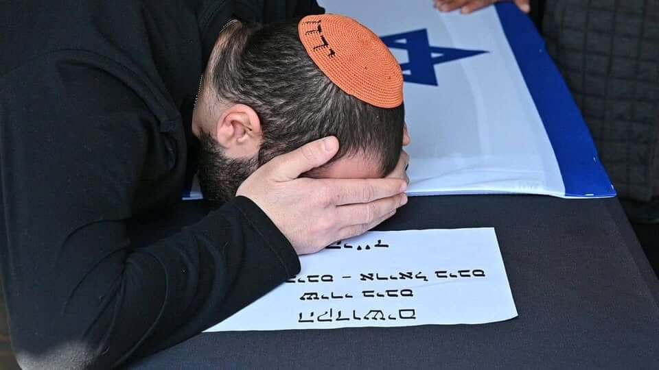 Yarden at the funeral wearing an orange kippah. (Credit: GPO)