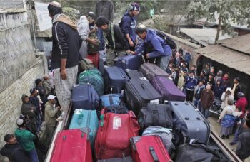 Bnei Menashe men load luggage onto a truck to start their journey towards Israel. (Shavei Israel)