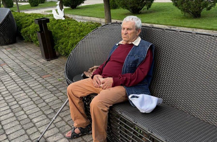 Yefgenia sits on a park bench during his daily walk